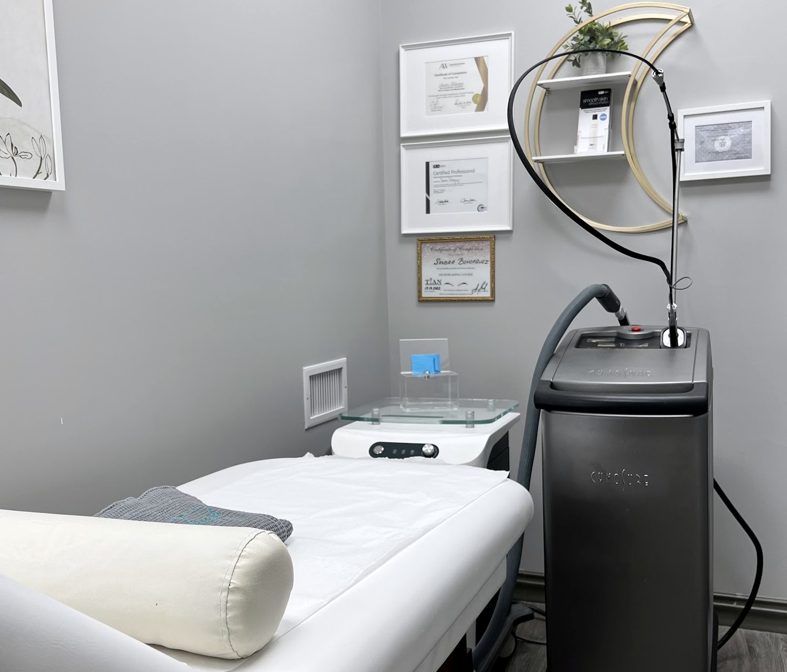 The treatment room at Touch Laser Spa, bed made and the laser ready